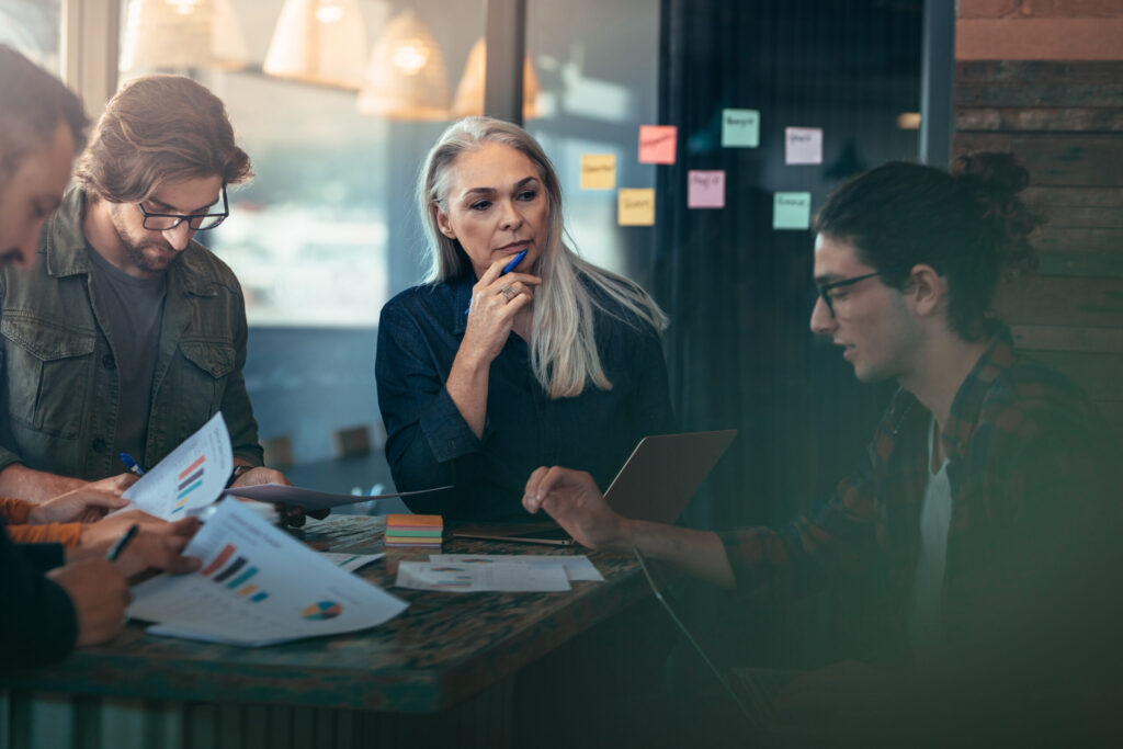 Group Of Business People Working And Communicating While Meeting At